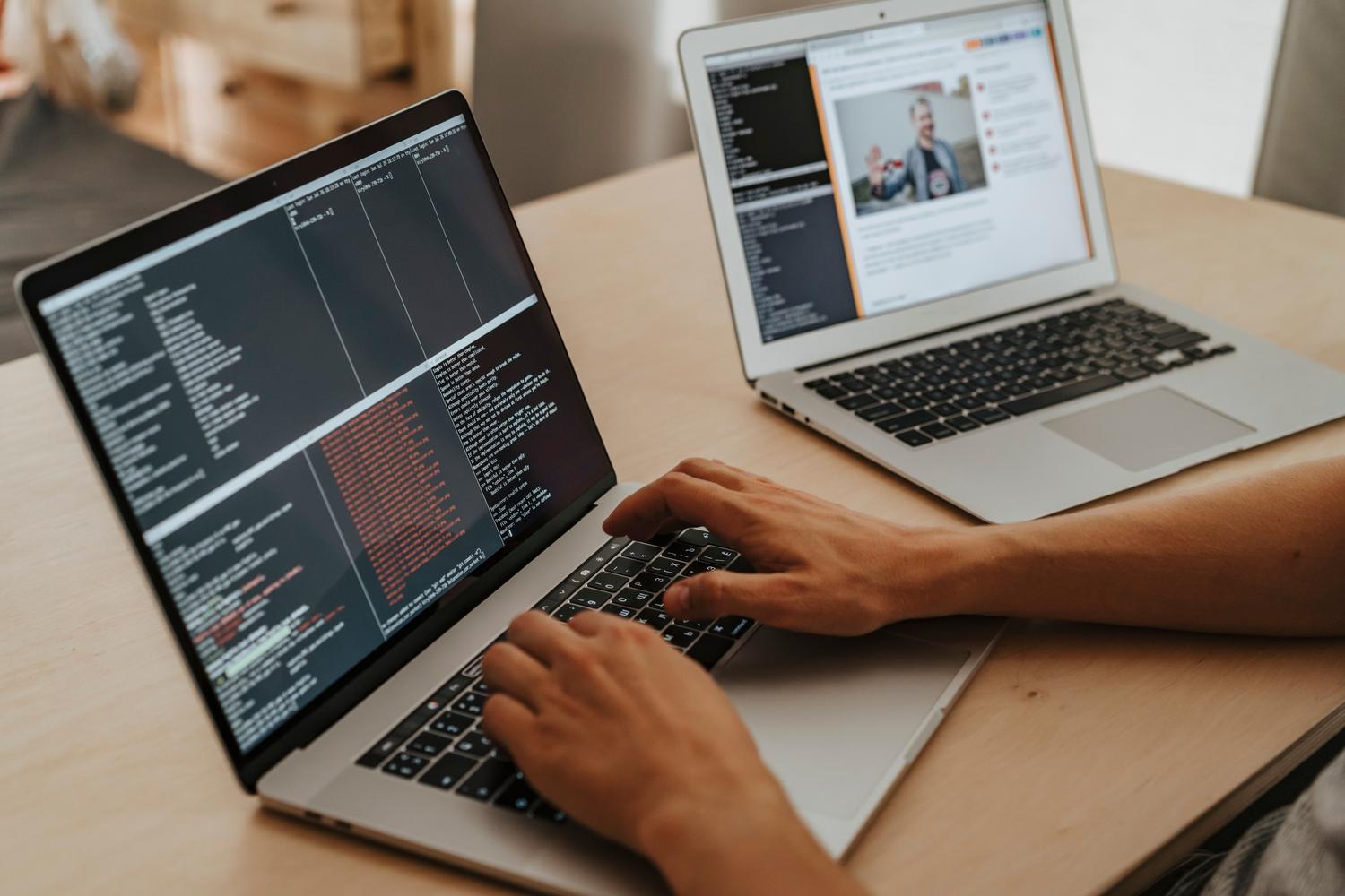 Programador trabajando en un portátil escribiendo código, representando el proceso de desarrollo de una herramienta personalizada para PDF.